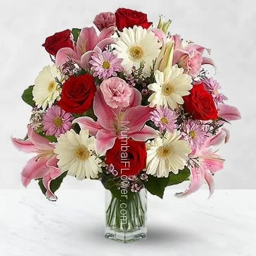 Glass vase with 20 Pink gerberas and  carnation, 10 red roses and 6 pc Asiatic pink lilies nicely decorated with fillers and greens