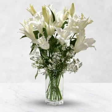 Glass vase with 5 pc Oriental White Lilies nicely decorated with greens... Please note : This item is not always available.