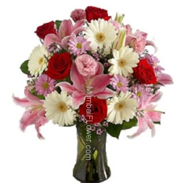 Valentine Special Product specially from top Florist. 10 Pink Carnation, 10 Red Roses, 15 Pink and White Gerbras and 5 PC Pink Lilies in a Clear Simple Glass Vase 