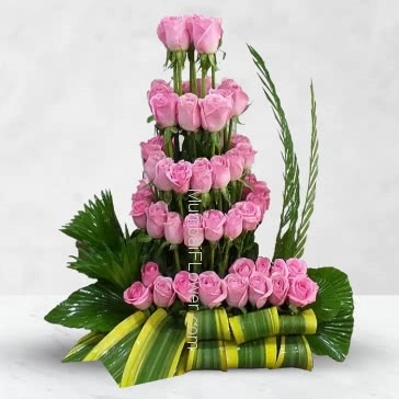 The rose has told
In one simplicity
That never life
Relinquishes a bloom
But to bestow
An ancient confidence. Arrangement of 60 Pink Roses nicely decorated with Greens.