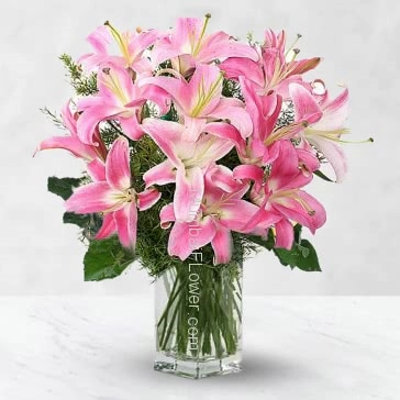 Bunch of 10 Beautiful Asiatic Pink Lilies nicely decorated with fillers and Ribbons send for the special occasion.  <br>Note : Color of Lilies may vary. Clear Glass vase is included.