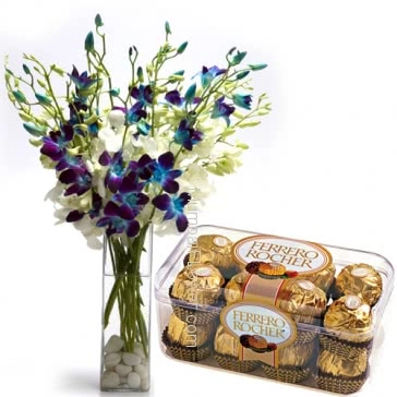 Glass vase with 10 Blue and white Orchids nicely decorated with 16pc Ferroro Rocher Chocolate. Please note: we may substitute flowers or color of flowers incase of unavailibiliy