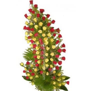 Tall Arrangement of 100 Red and Yellow Roses nicely decorated with greens