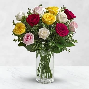 Glass vase with 15 mixed colored roses nicely decorated with greens