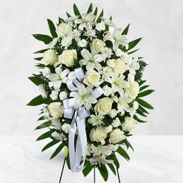 Flowers are peaceful and pure, offering hope and comfort during difficult times.
This standing spray arrangement is artistically designed by local florists with perfect white Flora for a difficult time of sorrow. Dedicated to one who was loved so deeply, let it be a wonderful and memorable tribute.
<br>Flowers: 
20 White Carnation, 40 White Roses and 8pc Asiatic White Lilies with fillers and greens decorated with white ribbons.