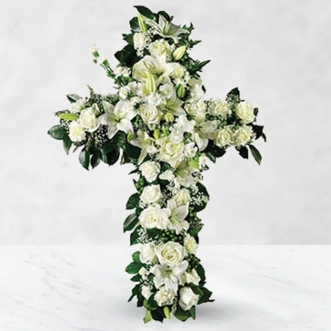 With its simple design, this floral cross is an elegant addition to any memorial ceremony, honoring someone whose faith had a profound impact on their lives.
<br>Cross contain Flowers: 
25 White Carnation, 15 White Roses and 8pc Asiatic White Lilies with fillers and greens decorated with white ribbons.