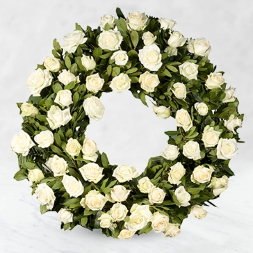 Your heart will always be filled with the memories of them. Share, remember, and honor their memories with an elegant and heartfelt tribute that expresses your deepest gratitude. Wreate gracefully arranged for display at the funeral.
<br>Arranged as: 
Round Wreath 70 White Roses with fillers, greens and decorated with white ribbons.