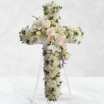 In a poignant and moving expression of faith, admiration, and divine love, a magnificent standing cross of purity soul blooms, remembers and honors the departed.
<br>Cross Arranged with: 
25 White Carnation, 25 White Roses, 20 stems of Sivanthi and 4pc Asiatic White Lilies with fillers and greens decorated with white ribbons.